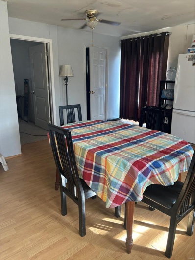 Dining space with ceiling fan and light hardwood / wood-style floors