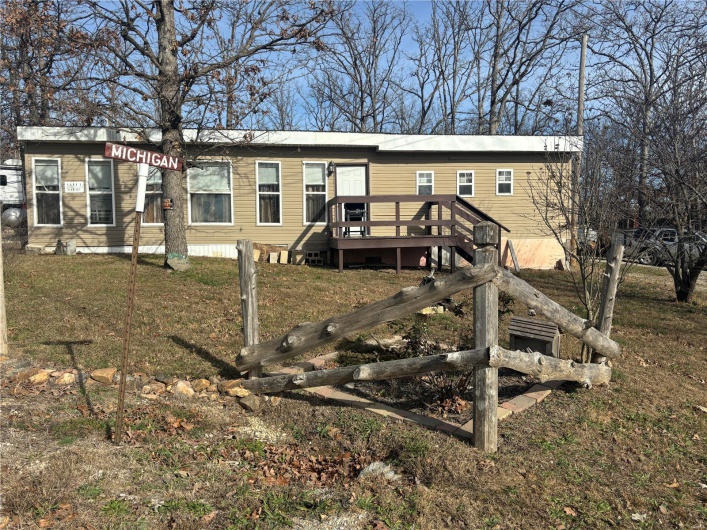 Rear view of property featuring a deck