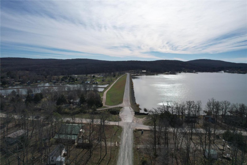 Birds eye view of property featuring a water and mountain view