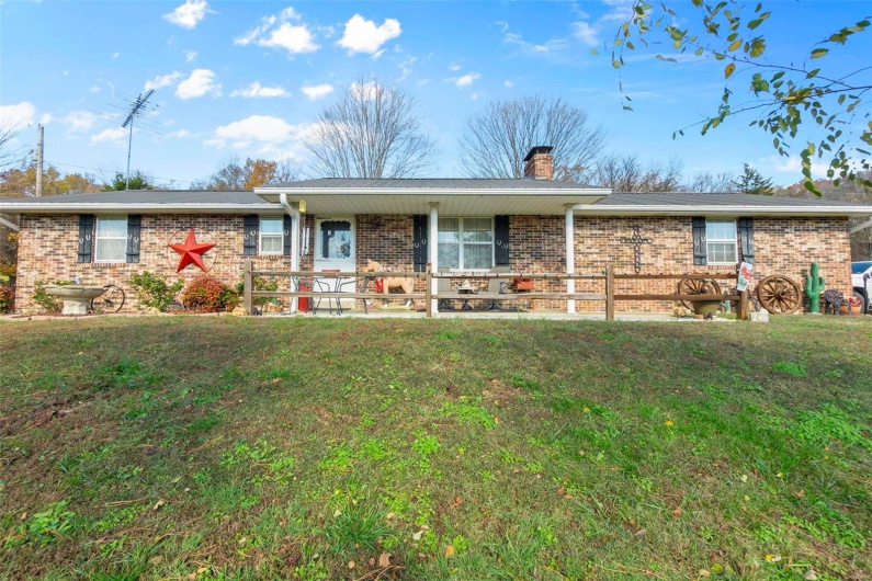 Single story home featuring a front lawn