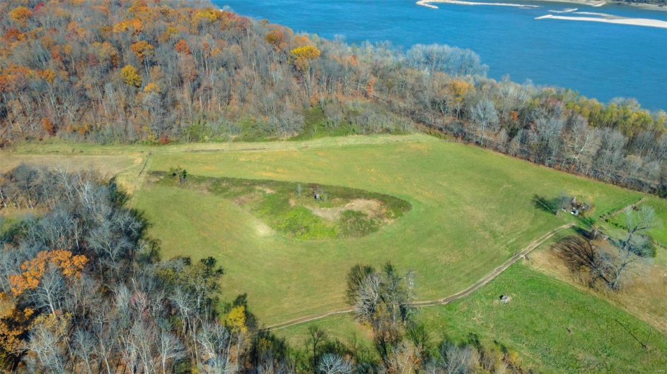 Birds eye view of property with a water view