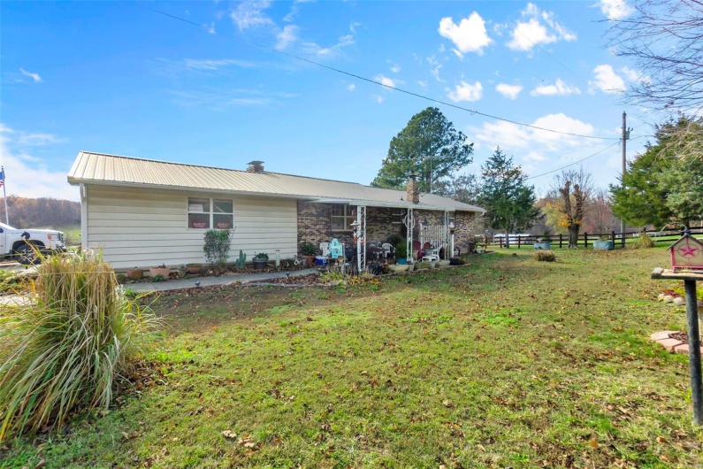 Rear view of house featuring a yard