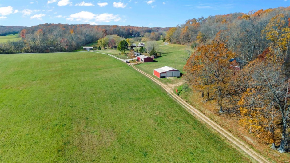 Birds eye view of property featuring a rural view