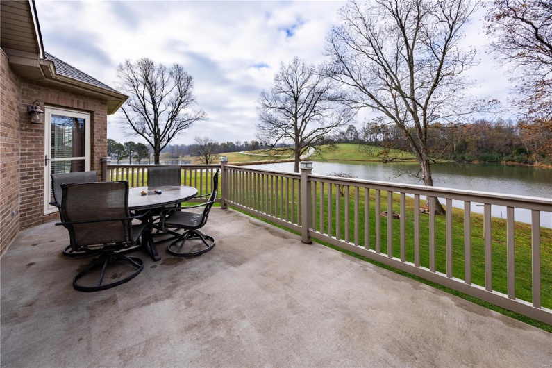 View of patio on rear of home with a water view.