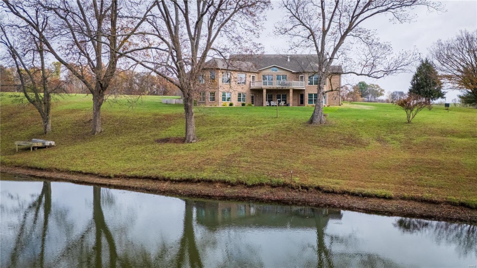 View of rear of property with lake.