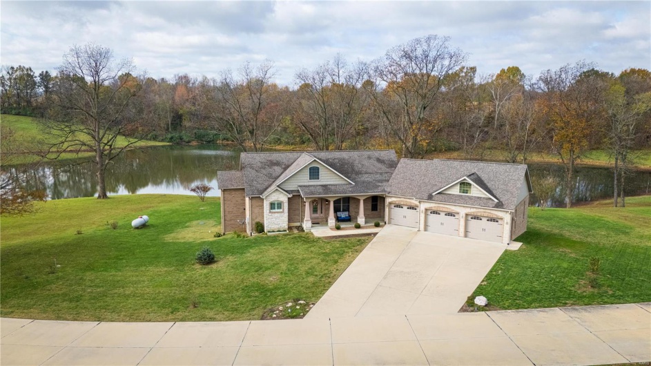 Aerial view of front of property with a water view.