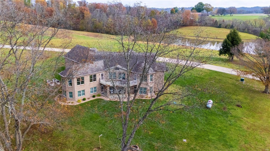 Aerial view of back of property with water views.