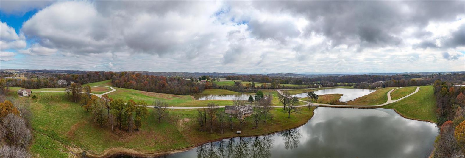 Aerial view of subdivision with water view.