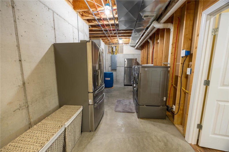 Basement with second laundry area and electric panel.