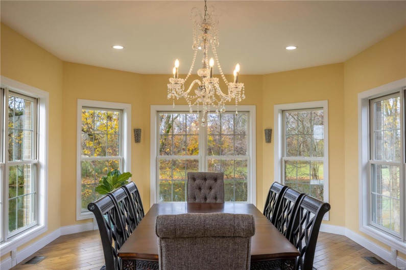 Dining room featuring  hardwood flooring and crystal chandelier.