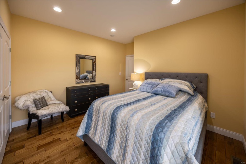 Bedroom with wood flooring.
