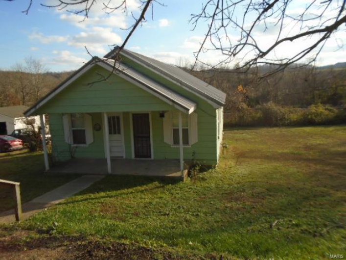 Bungalow-style home with a front lawn