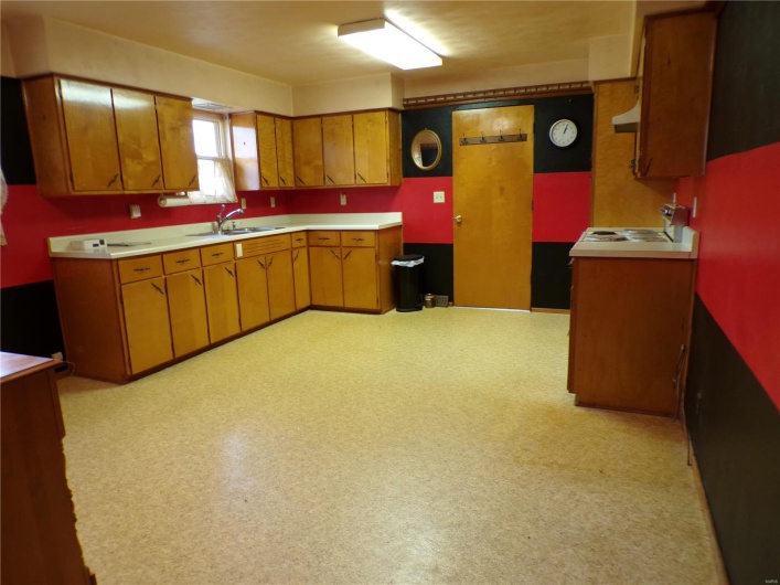 Good size Kitchen with wooden cabinets and exit to Garage.