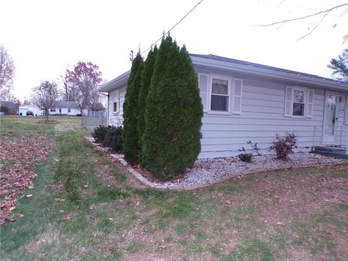 View of side of property with a yard