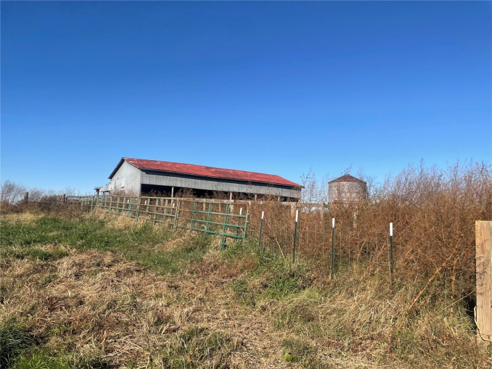 Exterior space with a rural view and an outdoor structure