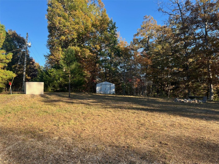 View of yard featuring a storage unit