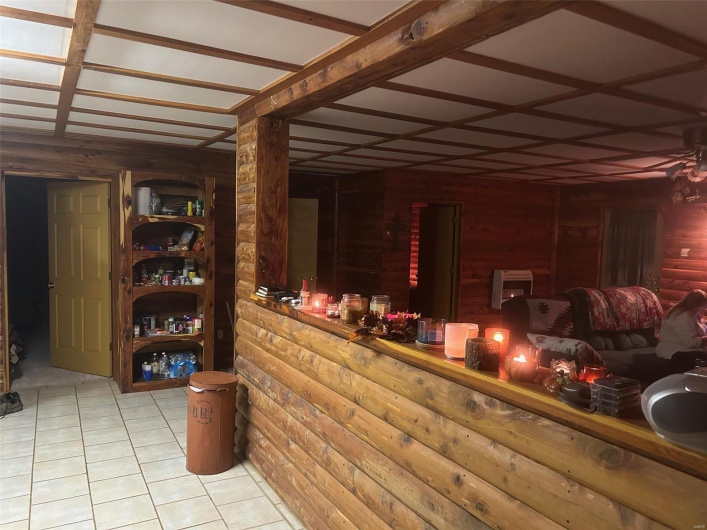 Wine area with wood walls and light tile patterned floors