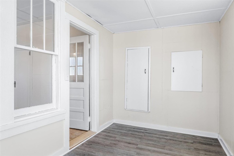 Spare room featuring dark wood-type flooring