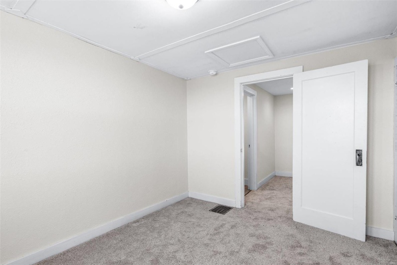 Unfurnished bedroom with light carpet