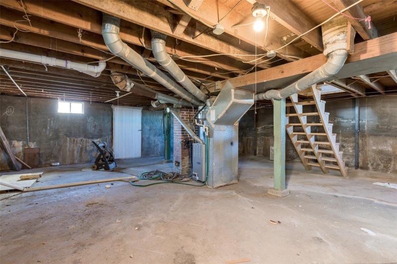 Basement featuring heating unit