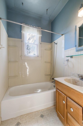 Bathroom featuring tile patterned floors, vanity, and shower / tub combination