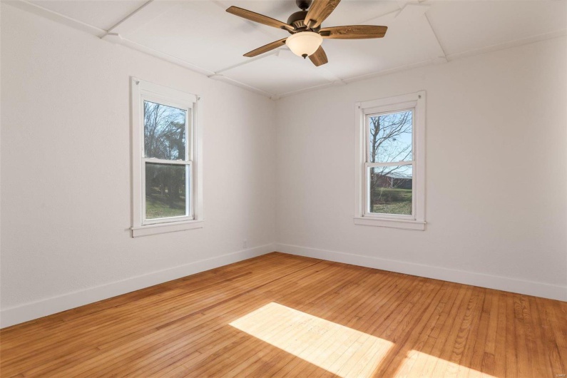 Spare room featuring ceiling fan and light hardwood / wood-style floors