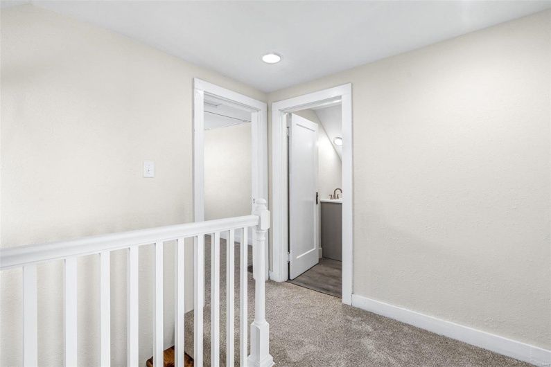 Corridor featuring carpet flooring