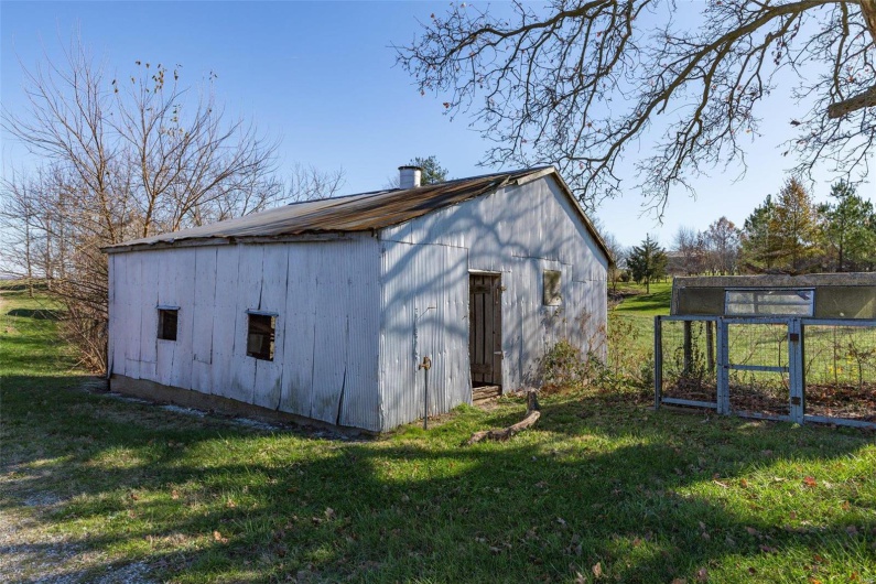 View of outdoor structure with a lawn