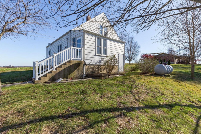 View of property exterior with a lawn