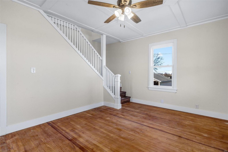 Stairway featuring ceiling fan and wood-type flooring