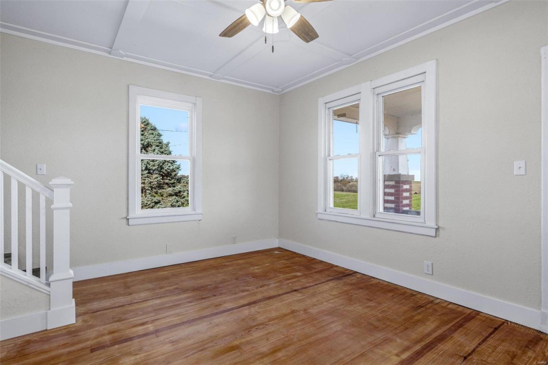 Spare room with hardwood / wood-style flooring and ceiling fan
