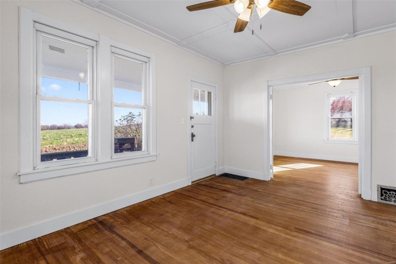 Entryway with ceiling fan and wood-type flooring