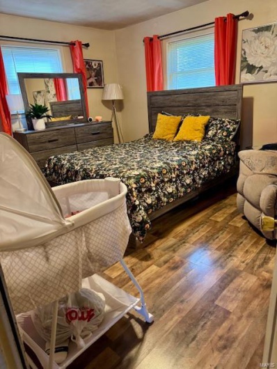 Bedroom with hardwood / wood-style flooring