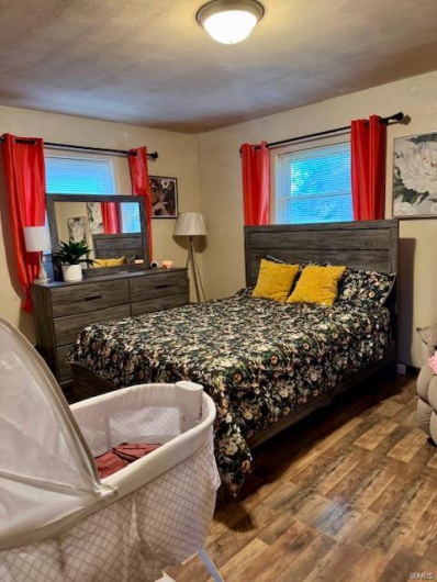 Bedroom with hardwood / wood-style flooring