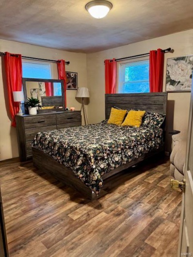 Bedroom with hardwood / wood-style flooring