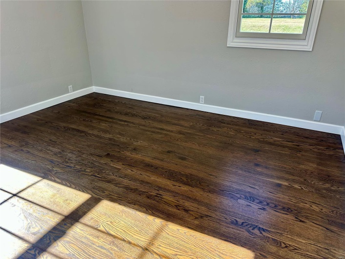 Unfurnished room featuring dark hardwood / wood-style flooring
