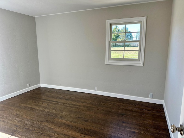 Spare room featuring dark hardwood / wood-style flooring