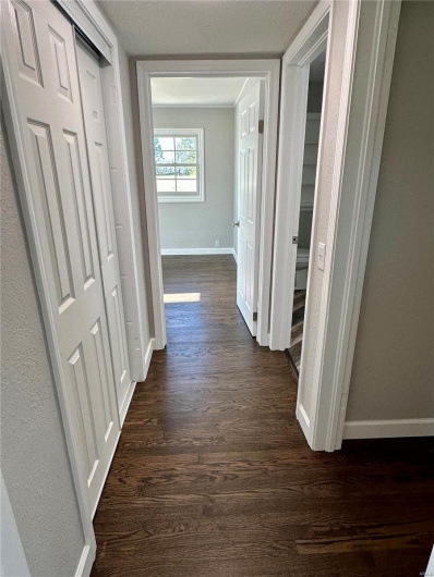 Corridor featuring dark wood-type flooring
