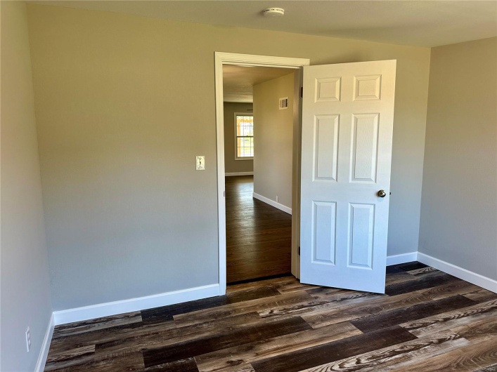 Unfurnished room featuring dark hardwood / wood-style floors