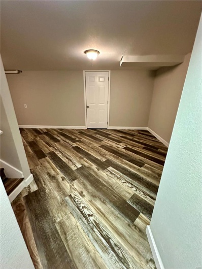 Empty room with dark wood-type flooring