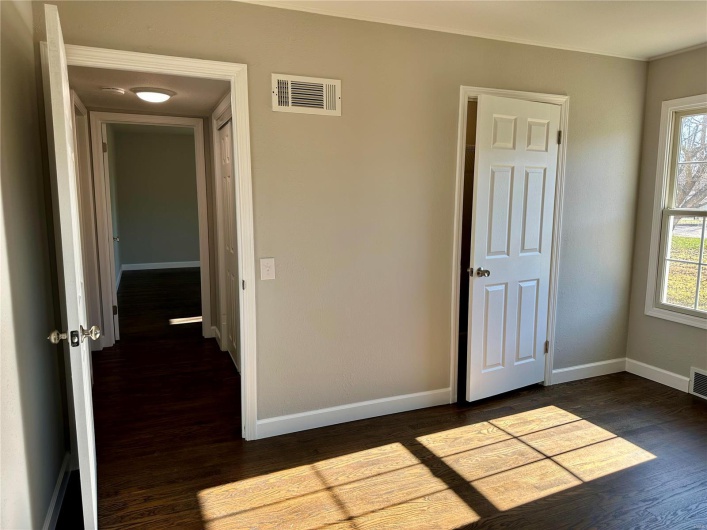 Interior space with dark hardwood / wood-style floors