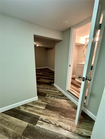 Hallway featuring dark wood-type flooring