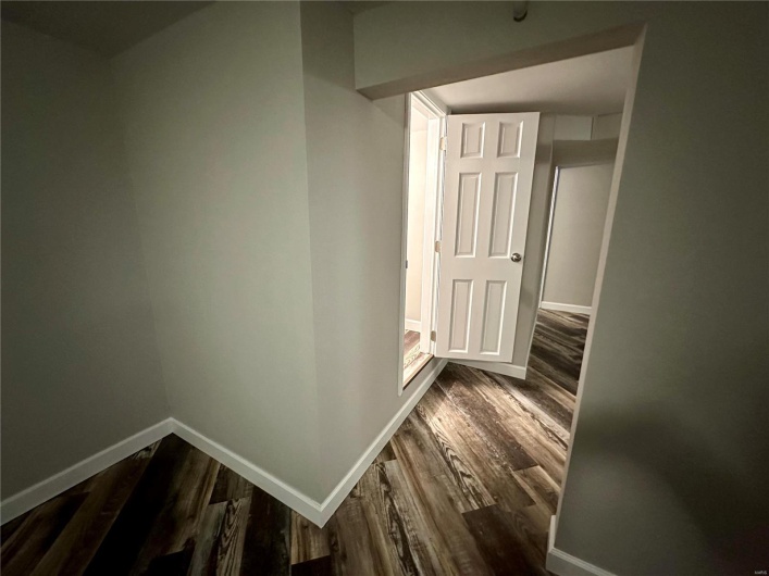 Corridor with dark hardwood / wood-style floors