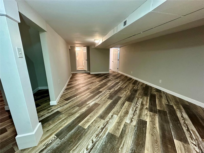 Unfurnished room featuring dark wood-type flooring