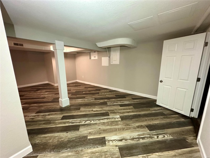 Basement featuring dark hardwood / wood-style floors