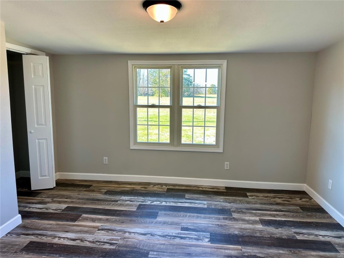Spare room with dark hardwood / wood-style floors