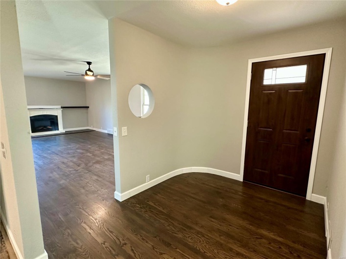 Entryway featuring ceiling fan and dark hardwood / wood-style floors