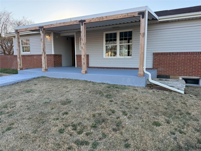 View of front of house with a front yard and a porch