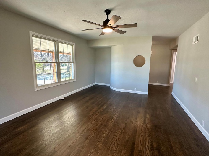 Spare room featuring ceiling fan, dark hardwood / wood-style flooring, and a textured ceiling