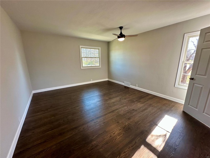 Foyer featuring ceiling fan and dark wood-type flooring